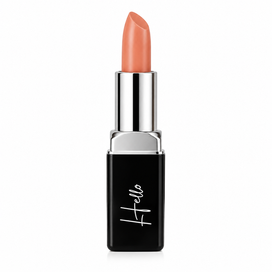 An open tube of Hello Biscuit Beauty Peach Tea creme lipstick rolled up to showcase the warm peach pink shade in its black casing with a white script logo on a clean white background