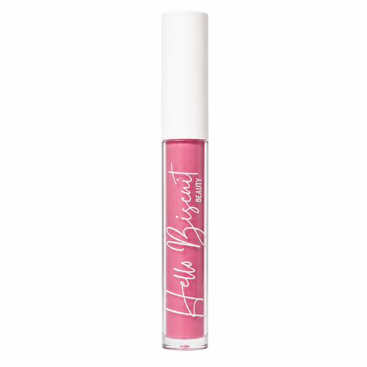 A standing clear tube of Hello Biscuit Beauty Strawberry Wine Lip Gloss showcasing the vibrant soft pink formula and white script logo on a white background