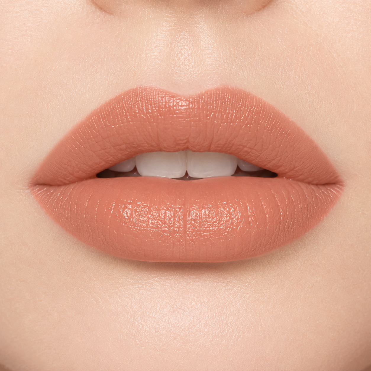 A smiling woman wearing Hello Biscuit Beauty 9 to 5 creme lipstick, showcasing a soft everyday light nude shade with a smooth creamy finish