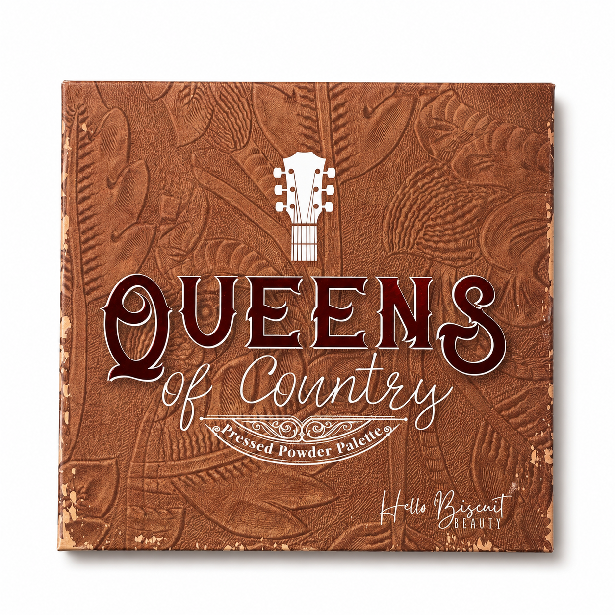 he closed cover of Hello Biscuit Beauty Queens of Country Eye Shadow Palette featuring a brown tooled leather texture with a white guitar illustration and script logo on a white background