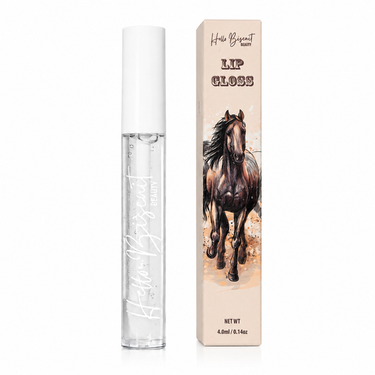 A clear tube of Hello Biscuit Beauty Cowboy Casanova Clear Lip Gloss next to its custom packaging box featuring a realistic brown horse illustration on a white background