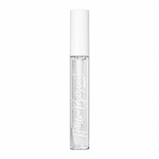 A standing clear tube of Hello Biscuit Beauty Cowboy Casanova Clear Lip Gloss showing the crystal clear formula and white script logo on a white background