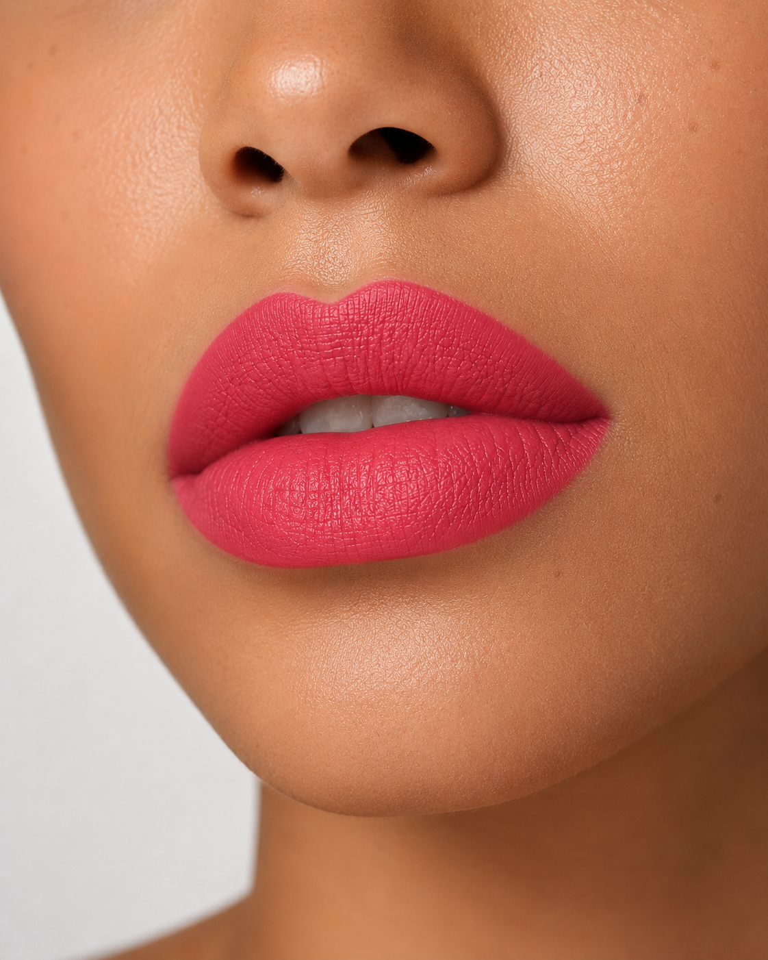A stunning close up view of full lips wearing Hello Biscuit Beauty Gone Country matte lipstick, a soft rosy pink shade with a smooth velvet finish