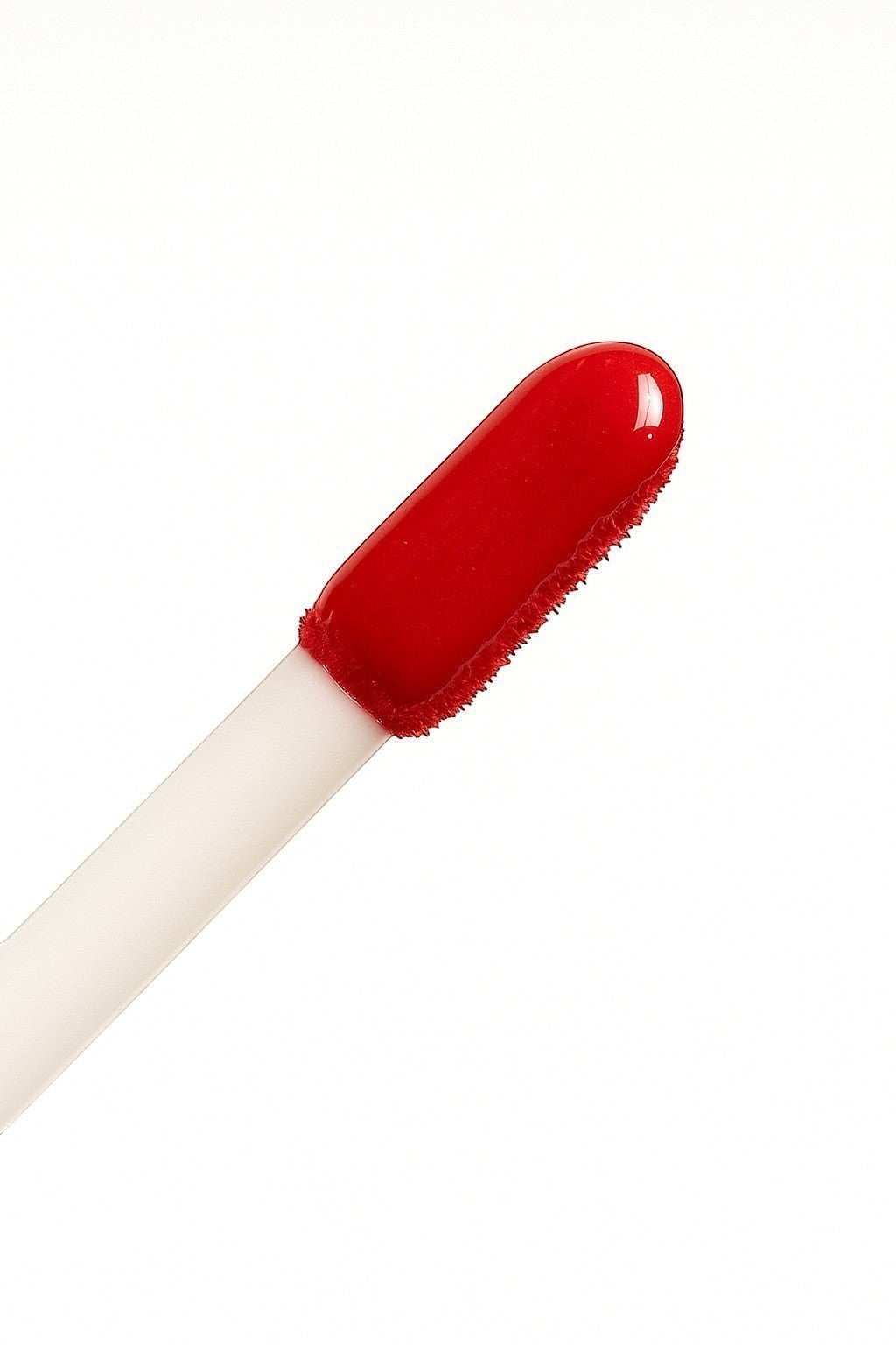 Hello Biscuit Beauty Two Dozen Roses lip gloss in vibrant true red with a high-shine finish.