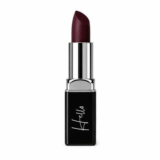 An open tube of Hello Biscuit Beauty Jolene matte lipstick rolled up to showcase the rich sparkling burgundy red wine shade in its black casing with a white script logo on a clean white background