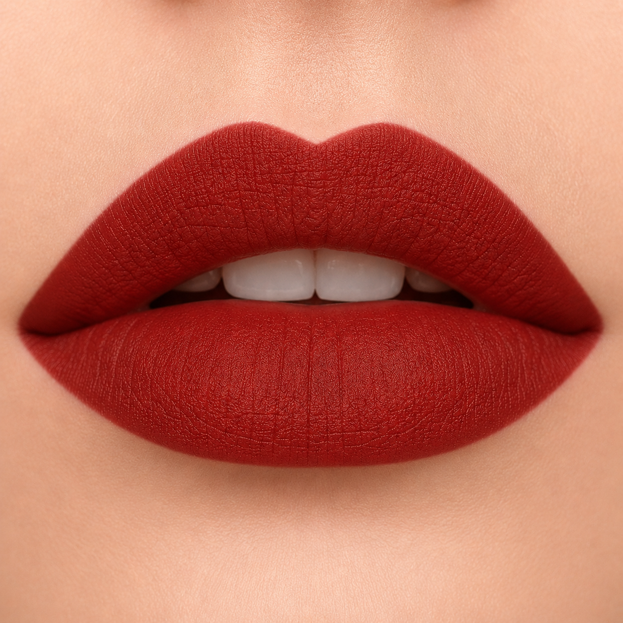 A detailed close up view of full lips wearing Hello Biscuit Beauty My Maria matte lipstick, a deep burnt red shade with a velvet matte finish