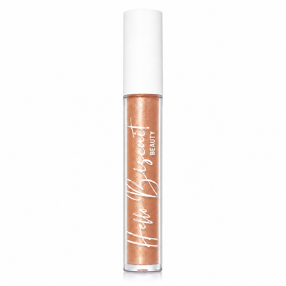 A clear tube of Hello Biscuit Beauty Palomino Sparkly Mocha Lip Gloss showcasing the shimmering mocha liquid formula and white logo on a white background