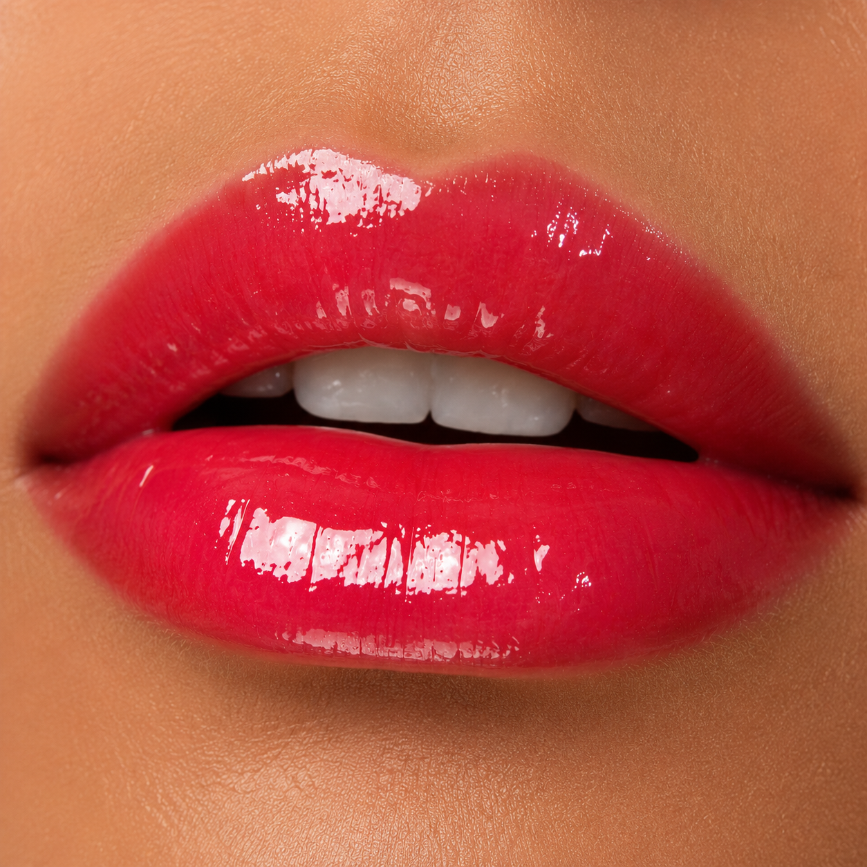 A detailed close up of full lips wearing Hello Biscuit Beauty Two Dozen Roses lip gloss, a vibrant true red shade with an ultra shiny glossy finish