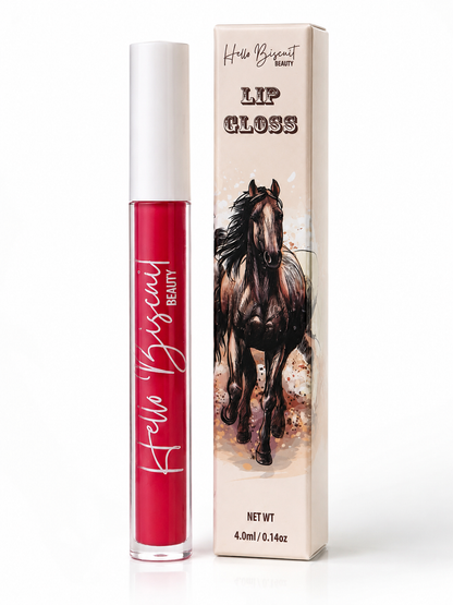 A clear tube of Hello Biscuit Beauty Two Dozen Roses vibrant red lip gloss standing next to its custom white product box featuring a beautiful illustration of a running brown horse