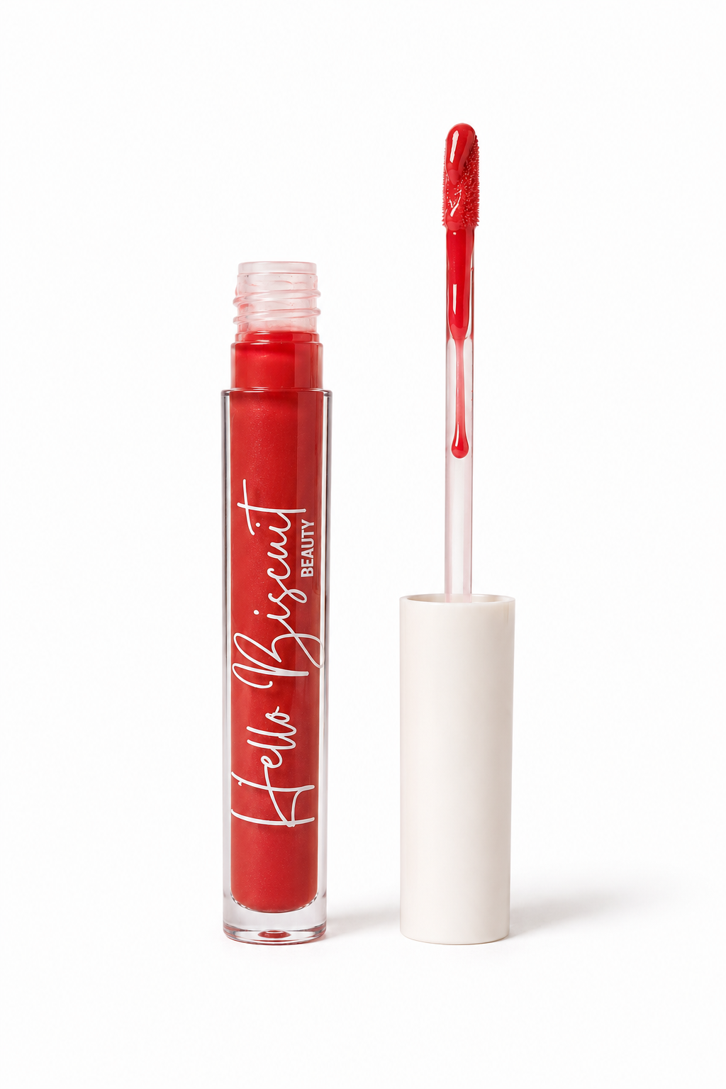 An open clear tube of Hello Biscuit Beauty Two Dozen Roses lip gloss standing upright with the white cap off and the doe foot applicator wand pulled out to show the vibrant true red glossy formula